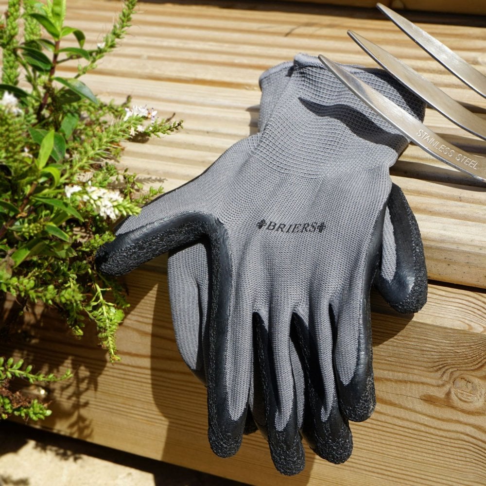 Grey gardening gloves on a wooden surface